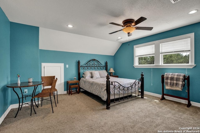 carpeted bedroom with ceiling fan, lofted ceiling, and a textured ceiling