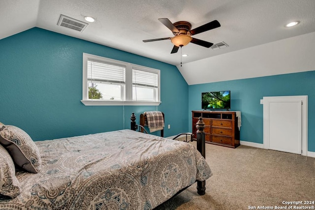 carpeted bedroom with lofted ceiling, a textured ceiling, and ceiling fan