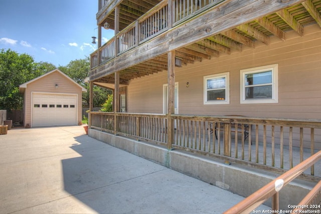 view of home's exterior featuring an outbuilding, a garage, and a balcony