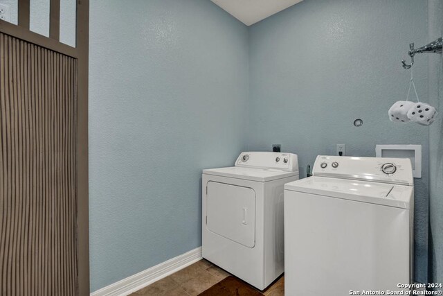 clothes washing area with washing machine and clothes dryer