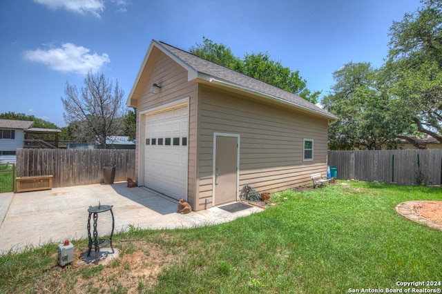 garage featuring a lawn