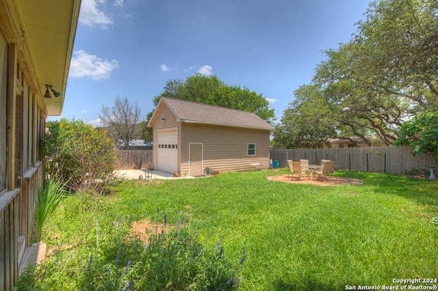 view of yard with a garage and an outdoor structure