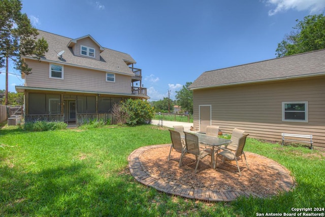rear view of house featuring a yard and a patio