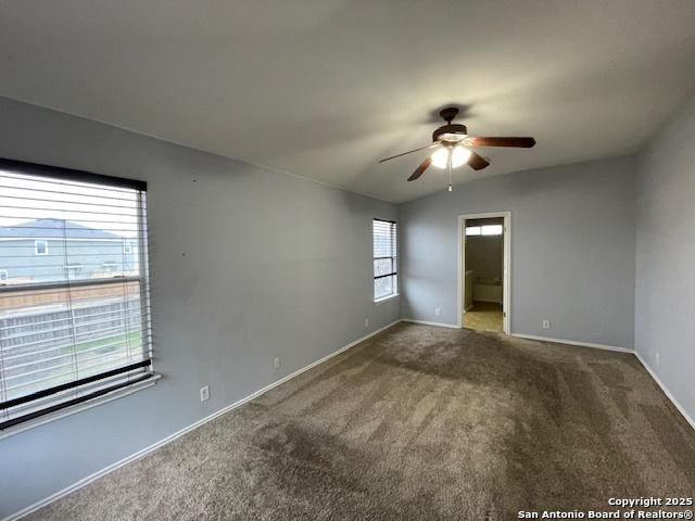 unfurnished room with ceiling fan, carpet, and baseboards