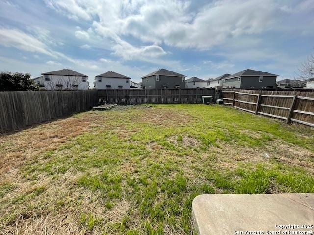 view of yard with a residential view and a fenced backyard