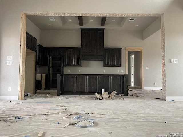 kitchen featuring a high ceiling, a tray ceiling, and ventilation hood