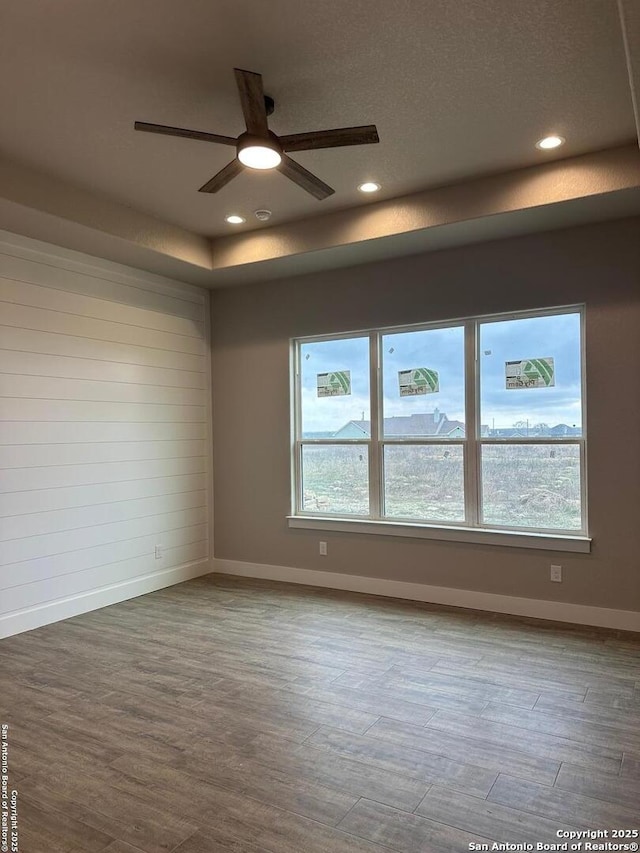 empty room with hardwood / wood-style flooring and ceiling fan