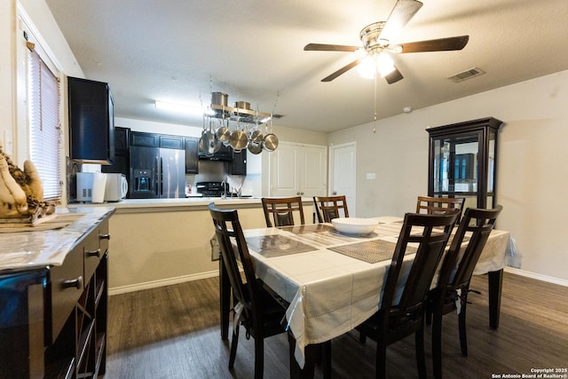 dining room with ceiling fan and dark hardwood / wood-style floors