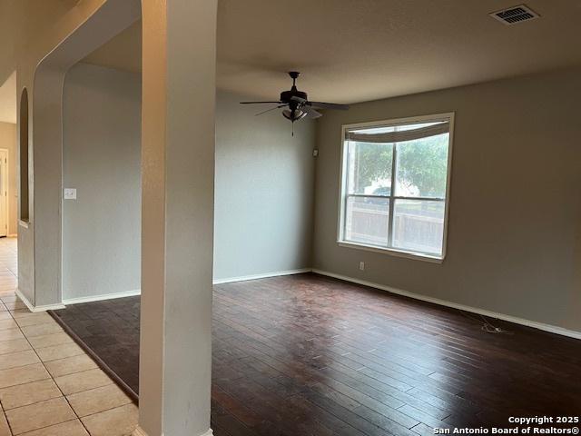 empty room with light hardwood / wood-style floors and ceiling fan