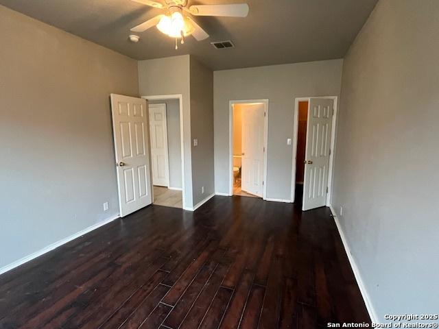 unfurnished bedroom with dark wood-type flooring and ceiling fan