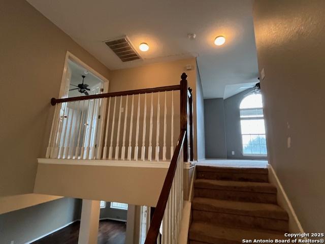 stairs with ceiling fan