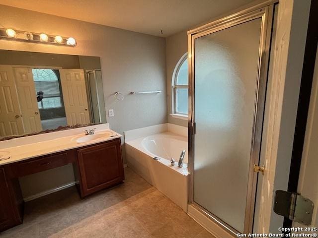 bathroom with vanity, tile patterned floors, and plus walk in shower