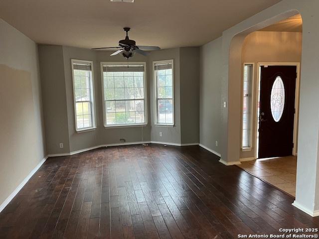 foyer featuring ceiling fan, a healthy amount of sunlight, and dark hardwood / wood-style floors