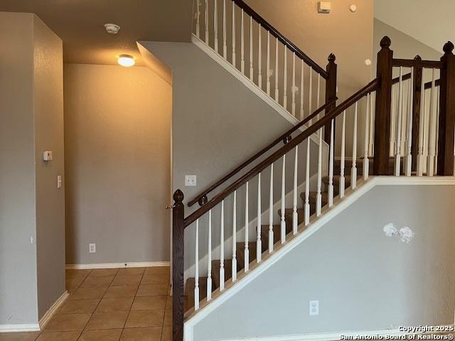 staircase featuring tile patterned floors