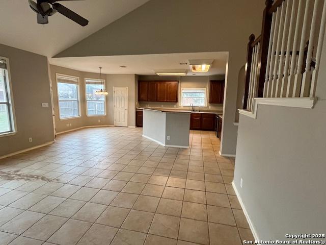 kitchen with light tile patterned floors, sink, plenty of natural light, and a center island