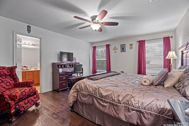 bedroom with multiple windows, ensuite bathroom, dark hardwood / wood-style floors, and ceiling fan