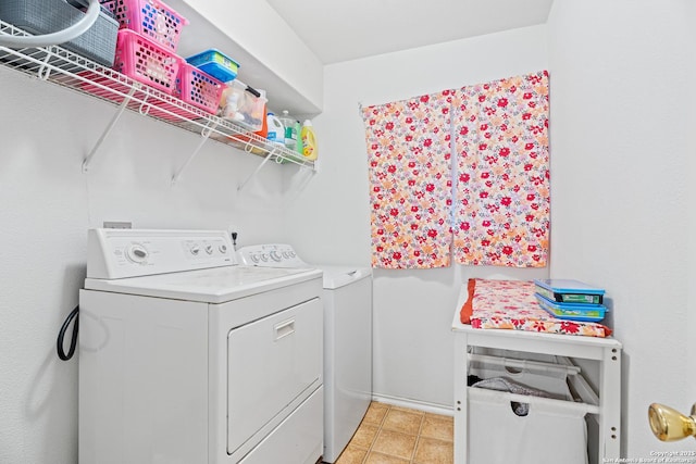 washroom with washing machine and dryer and light tile patterned floors