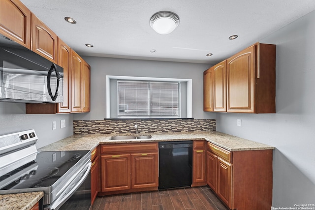 kitchen with sink, backsplash, black appliances, and dark hardwood / wood-style floors