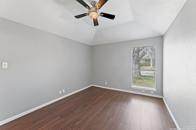 unfurnished room featuring lofted ceiling, dark wood-type flooring, and ceiling fan