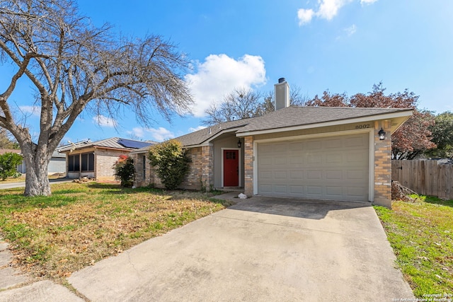 ranch-style house featuring a garage and a front yard