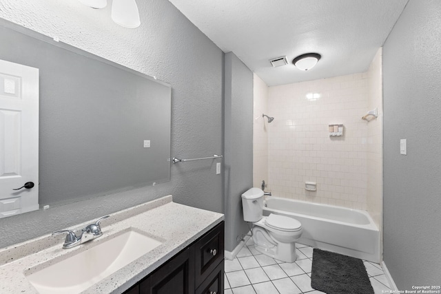 full bathroom featuring tiled shower / bath combo, vanity, a textured ceiling, tile patterned floors, and toilet