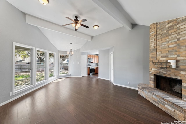 unfurnished living room with dark hardwood / wood-style floors, ceiling fan with notable chandelier, a brick fireplace, and vaulted ceiling with beams