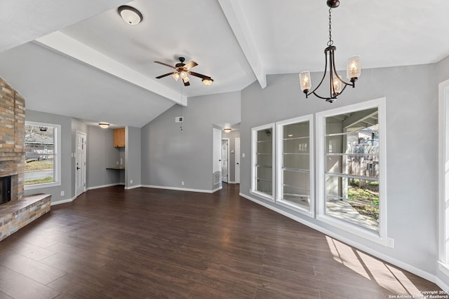 unfurnished living room with dark wood-type flooring, a fireplace, lofted ceiling with beams, and ceiling fan with notable chandelier