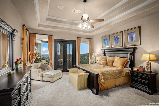 carpeted bedroom featuring crown molding, a raised ceiling, multiple windows, and access to outside