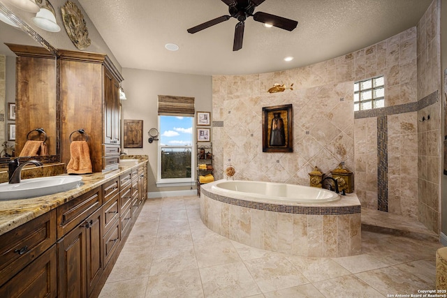 bathroom with vanity, tile patterned floors, shower with separate bathtub, and a textured ceiling