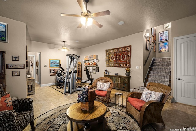 living area featuring a textured ceiling and ceiling fan