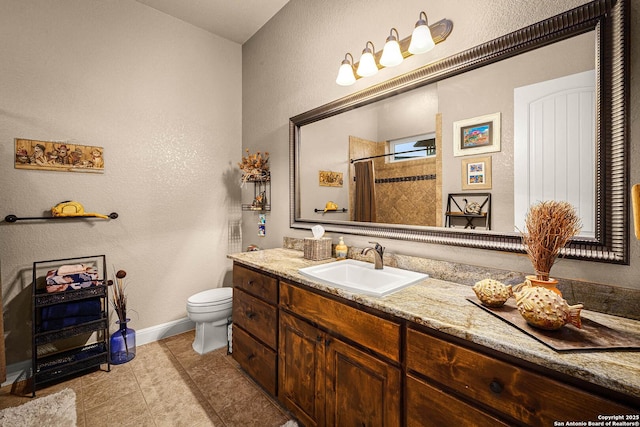 bathroom with tile patterned floors, vanity, toilet, and curtained shower