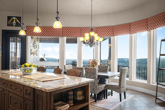 tiled dining room with an inviting chandelier