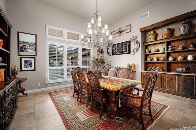 dining room featuring a chandelier and light tile patterned floors