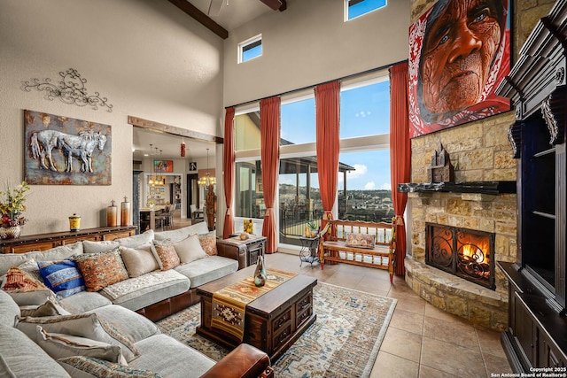 living room featuring a fireplace, light tile patterned flooring, and a high ceiling