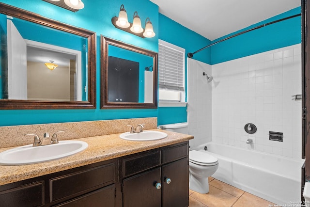 full bathroom featuring vanity, tiled shower / bath combo, tile patterned floors, and toilet