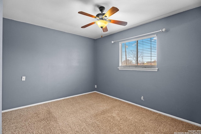 carpeted spare room with ceiling fan