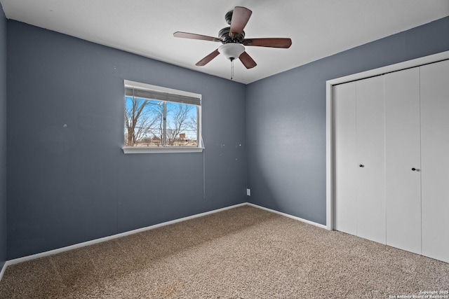 unfurnished bedroom with a closet, ceiling fan, and carpet flooring