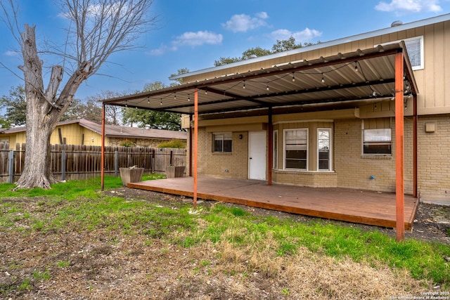 rear view of property featuring a yard and a deck