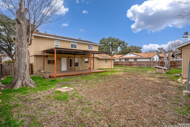 back of house with a deck