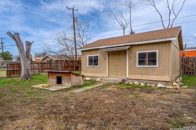 back of property with an outdoor structure