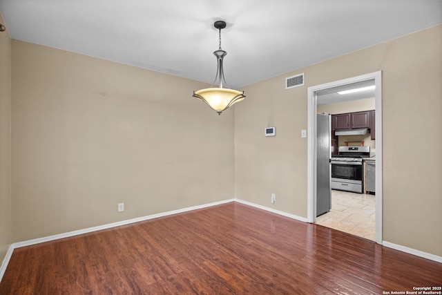 unfurnished room with light wood-type flooring