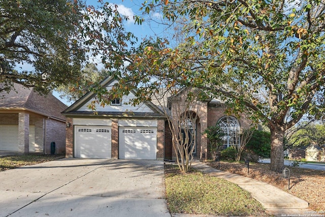 view of front of property with driveway, brick siding, and an attached garage