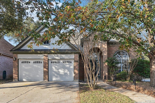 traditional home featuring brick siding and driveway