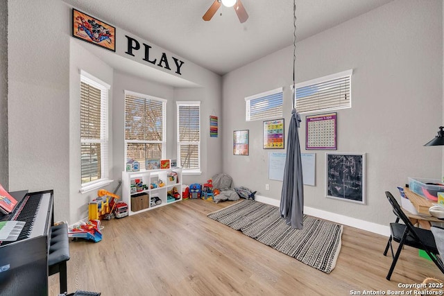 recreation room featuring wood-type flooring and ceiling fan