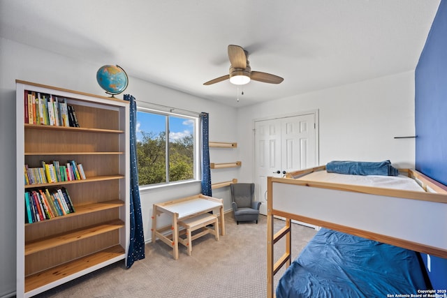 carpeted bedroom featuring a closet, a ceiling fan, and baseboards