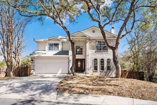 traditional home with a garage, concrete driveway, a chimney, fence, and brick siding