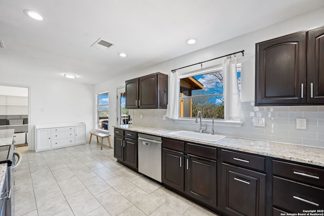 kitchen featuring backsplash, a sink, dark brown cabinets, light stone countertops, and dishwasher