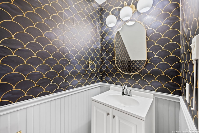 bathroom with a wainscoted wall and vanity