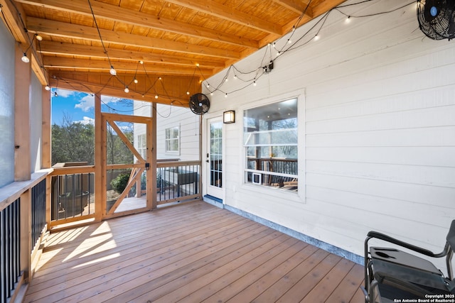 unfurnished sunroom featuring lofted ceiling with beams, wooden ceiling, and a wealth of natural light