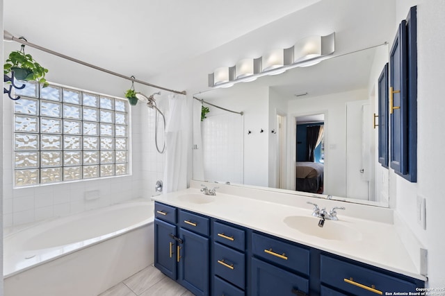 full bathroom featuring ensuite bathroom, double vanity, shower / bath combo, and a sink